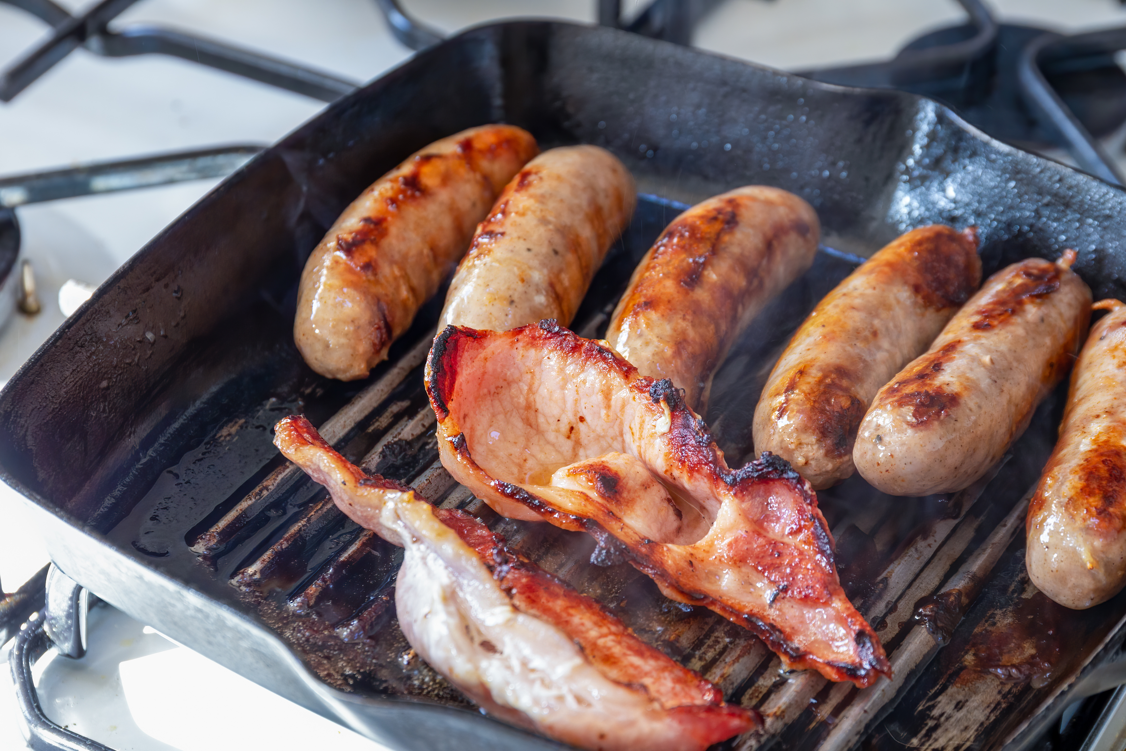 bacon and sausage in skillet